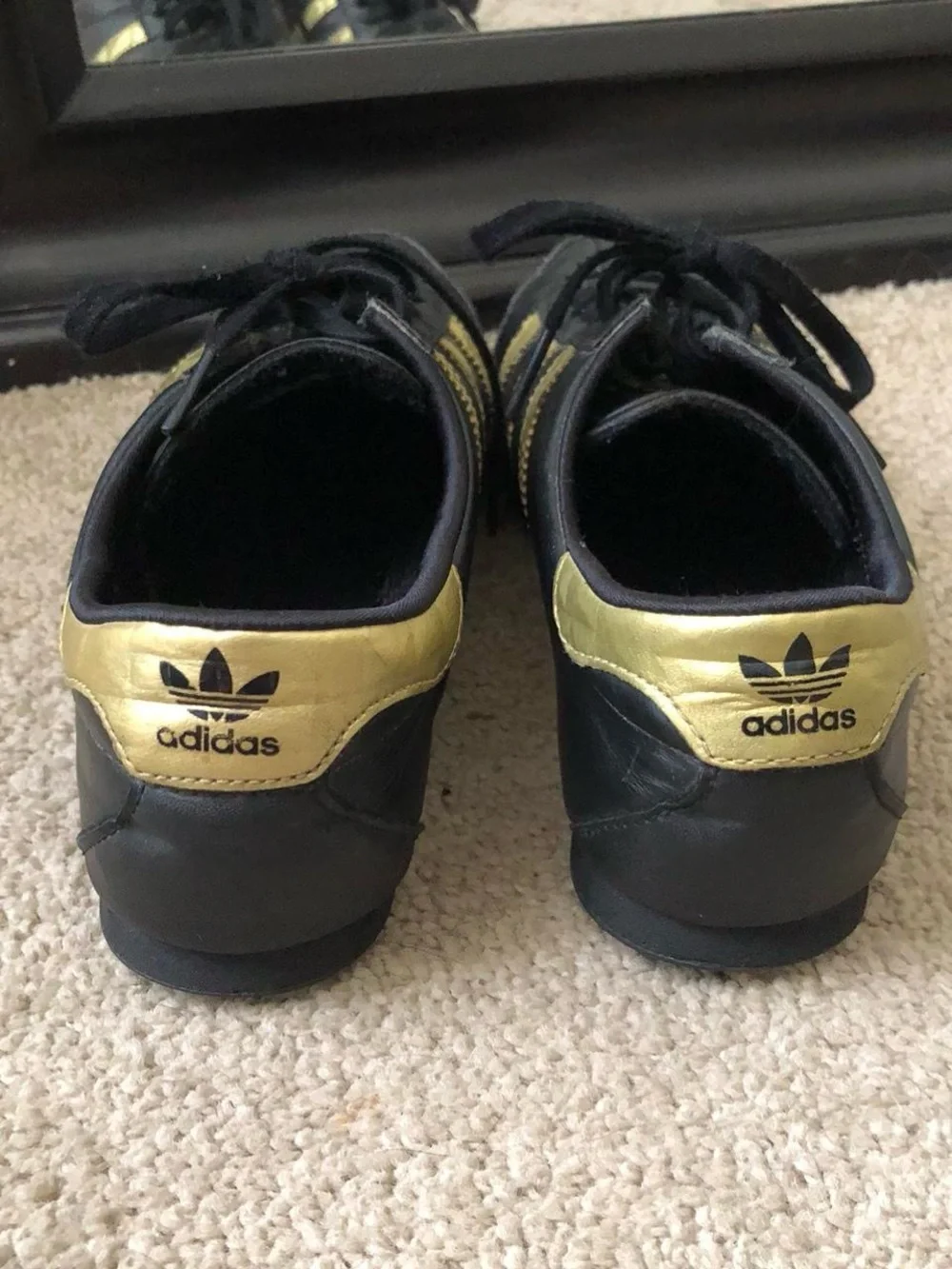 adidas Women’s Black Sneakers with Gold Stripes